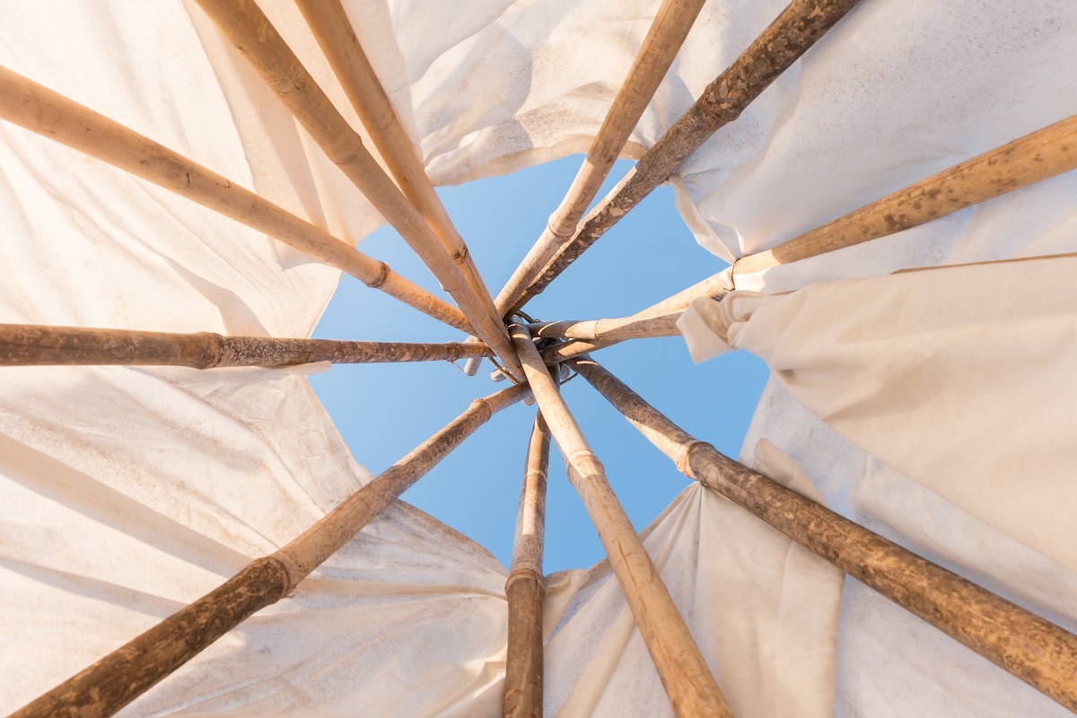 Looking up to the sky from inside a tipi